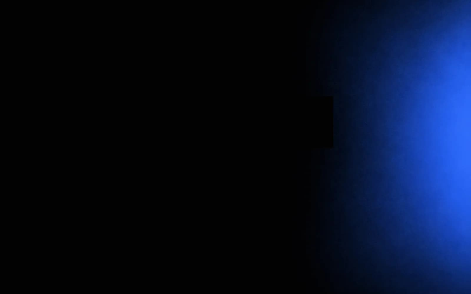 Deep blue light rising along the edge of a dark frame, steady systems for the Operationalise phase